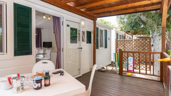 Terrazza con tavolo apparecchiato e sedie.