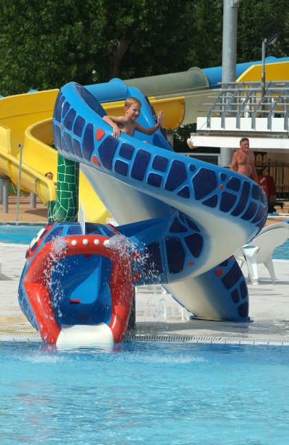 Scivolo d'acqua colorato in una piscina con bambini che giocano.